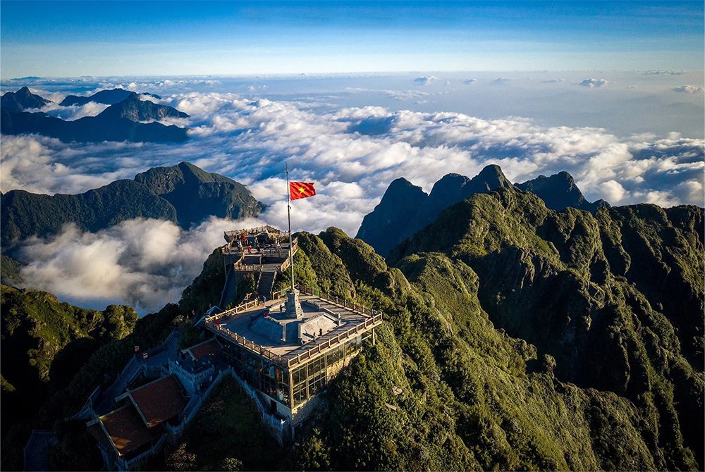 A striking image of the Vietnam flag set against a backdrop of majestic mountains, symbolizing the nation's natural beauty and pride.